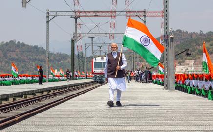 PM Modi waves the Tiranga after inaugurating the Chenab Bridge—the world’s highest railway arch bridge—in Reasi.