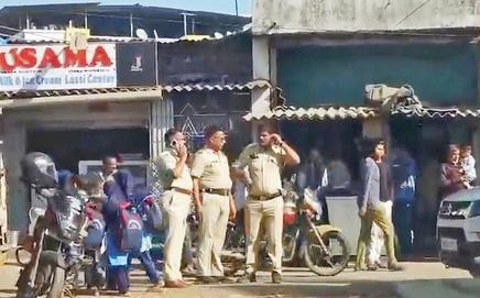 Police personnel stand guard as Enforcement Directorate officials conduct raids in Padgha, Thane district
