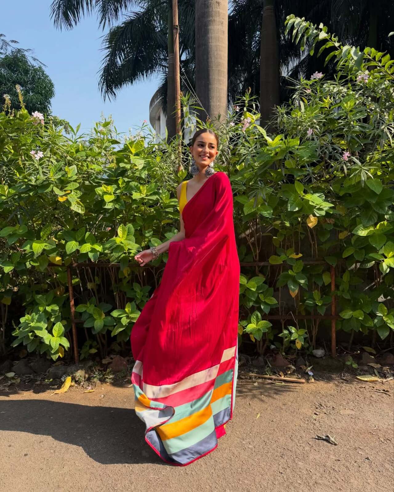 <p>Ananya stuns in a dark pink saree paired with a vibrant yellow blouse, creating a striking contrast that instantly draws attention. With her hair styled in a sleek bun, the look feels elegant yet youthful.</p>