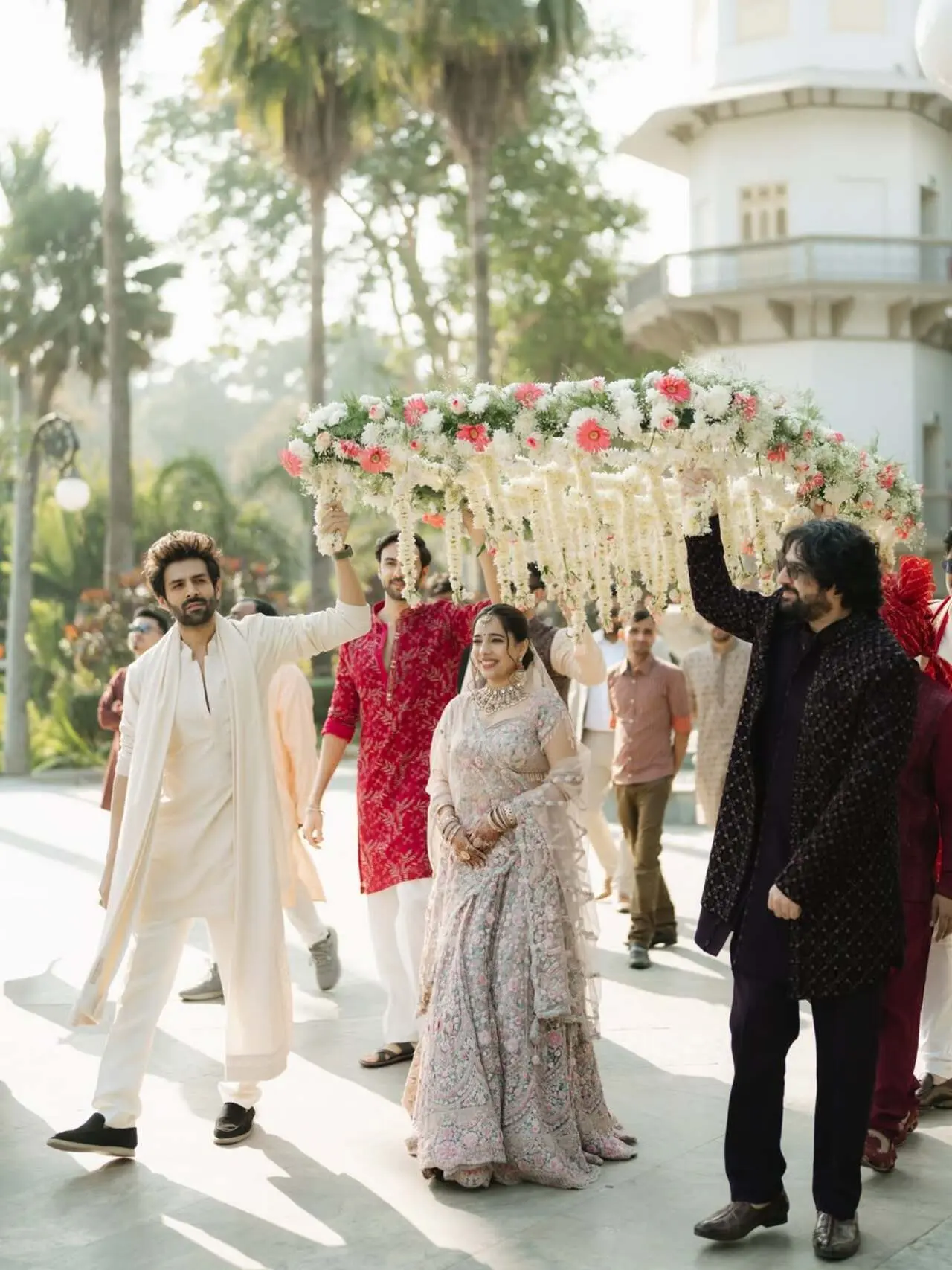Another lovely picture shows him holding the phoolon ki chaadar for his sister while walkingnis sister down the aisle.