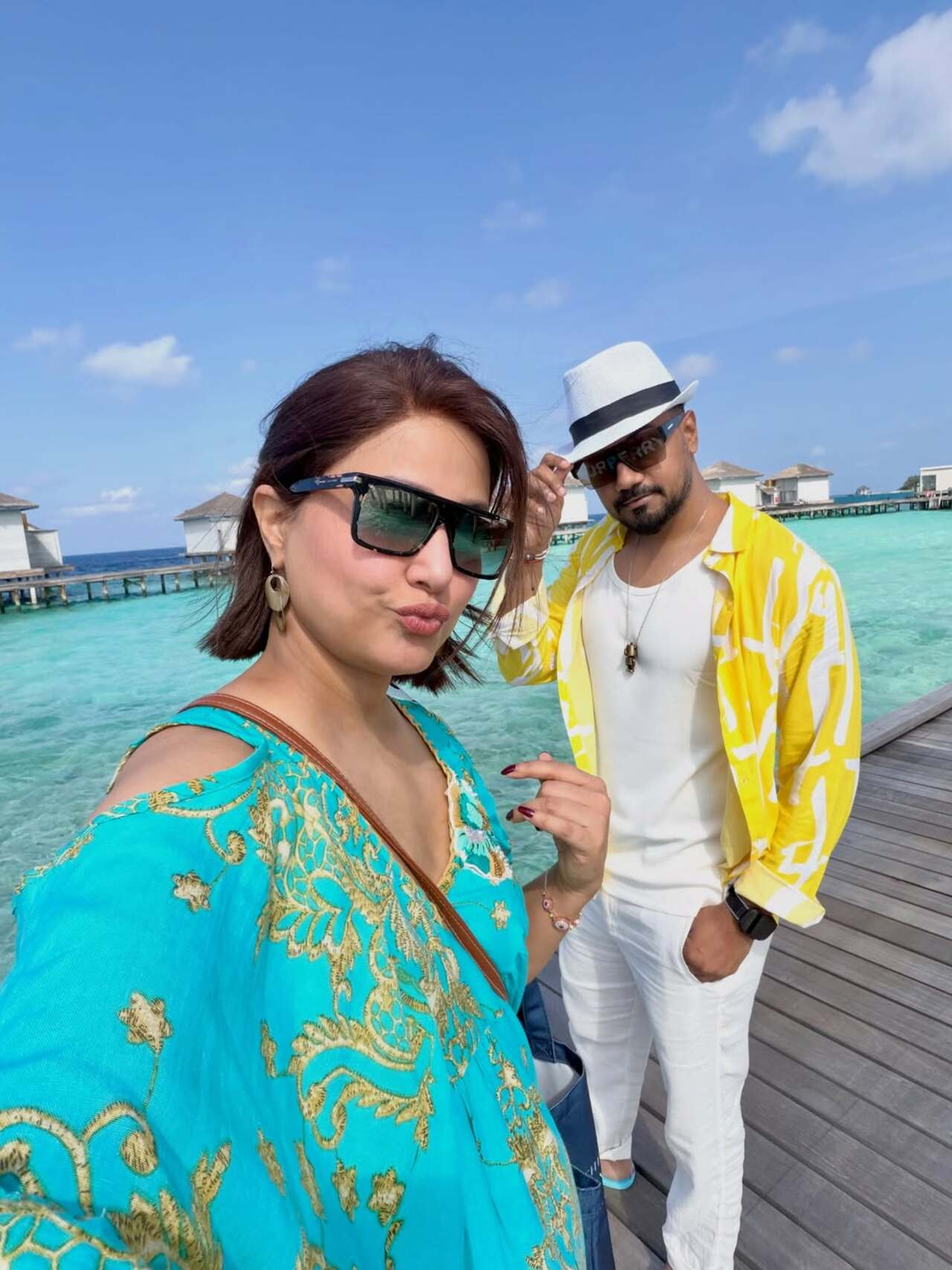 Hina was also seen posing alongside her husband Rocky Jaiswal and looked cute in her blue one-piece.