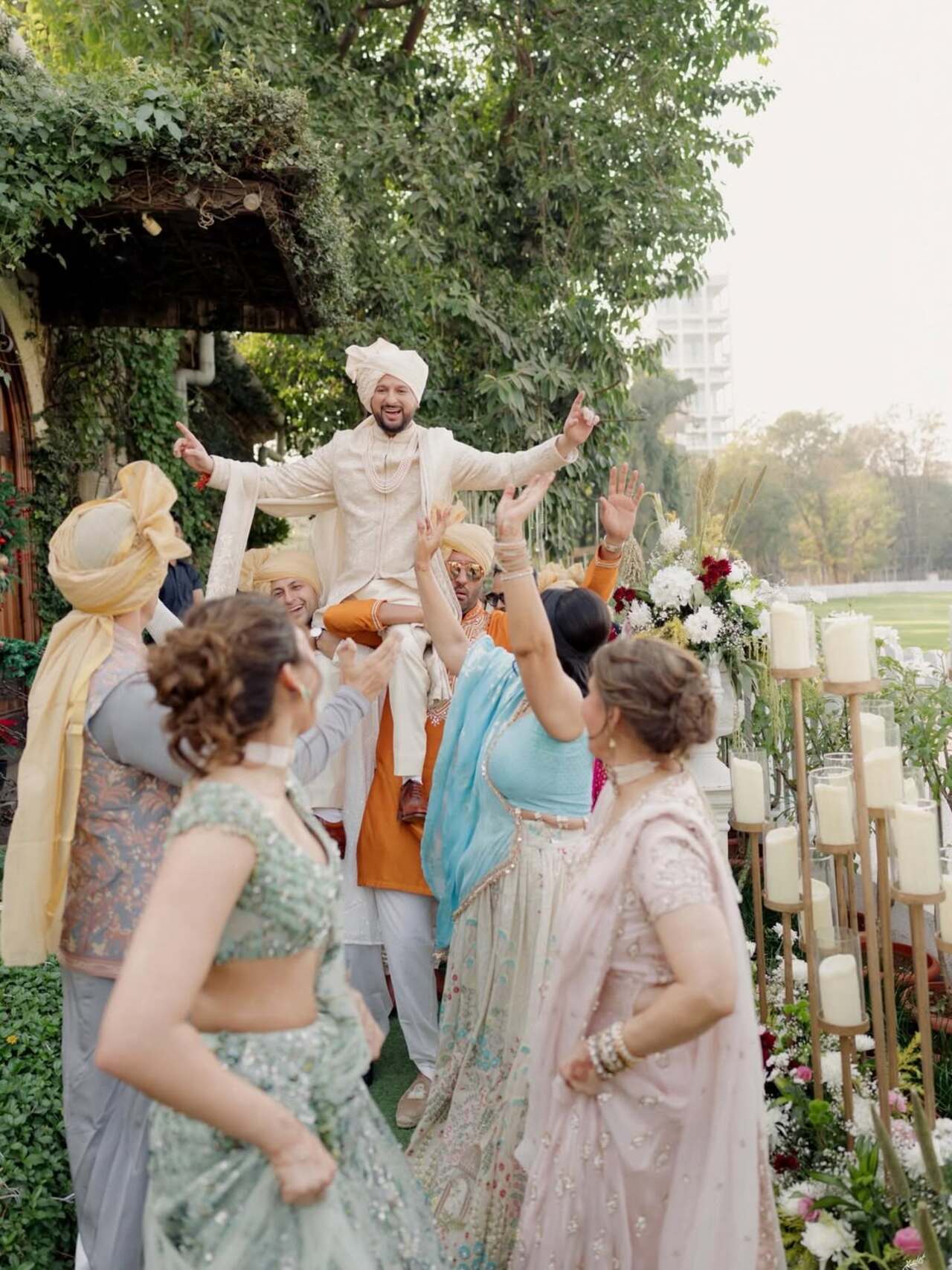 <p>Eshaan opts for an ivory sherwani that exudes understated royalty. He completes his look with a coordinated turban adorned with a subtle accent, and layered pearl necklace.</p>