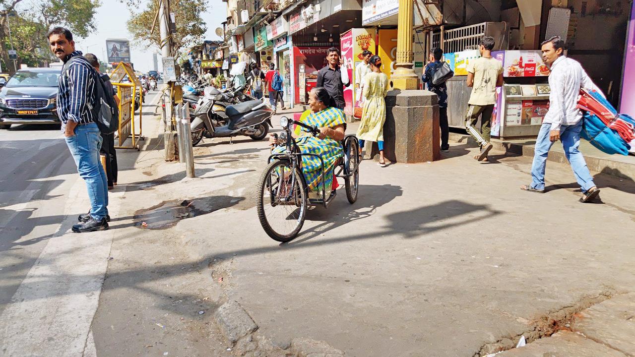Jayashree Jadhav, wheelchair-bound Byculla resident, who faces obstacles navigating streets. Shopkeepers have helped her by breaking the footpath to make it more accessible. PIC/RITIKA GONDHALEKAR