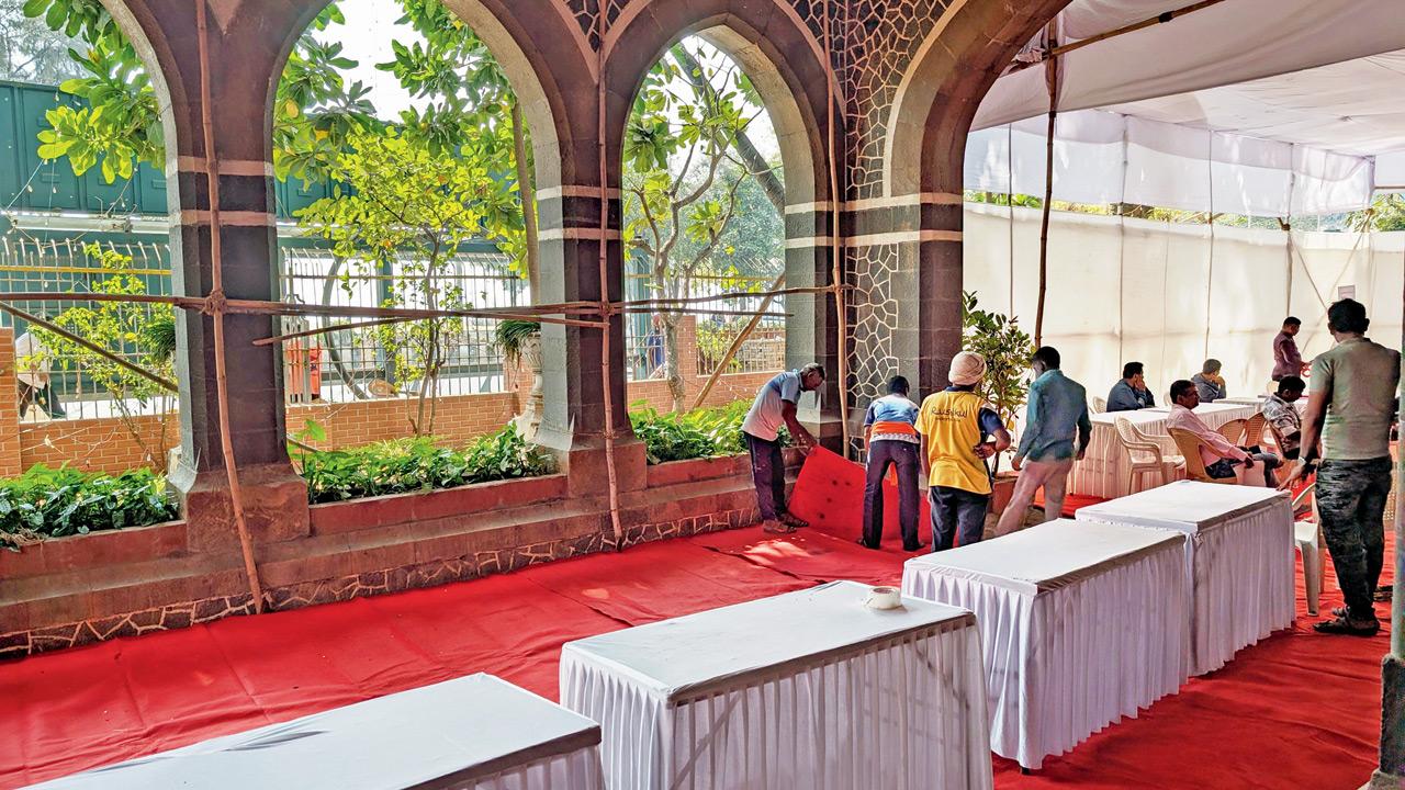 Election officials set up tables in front of the entrance to the college