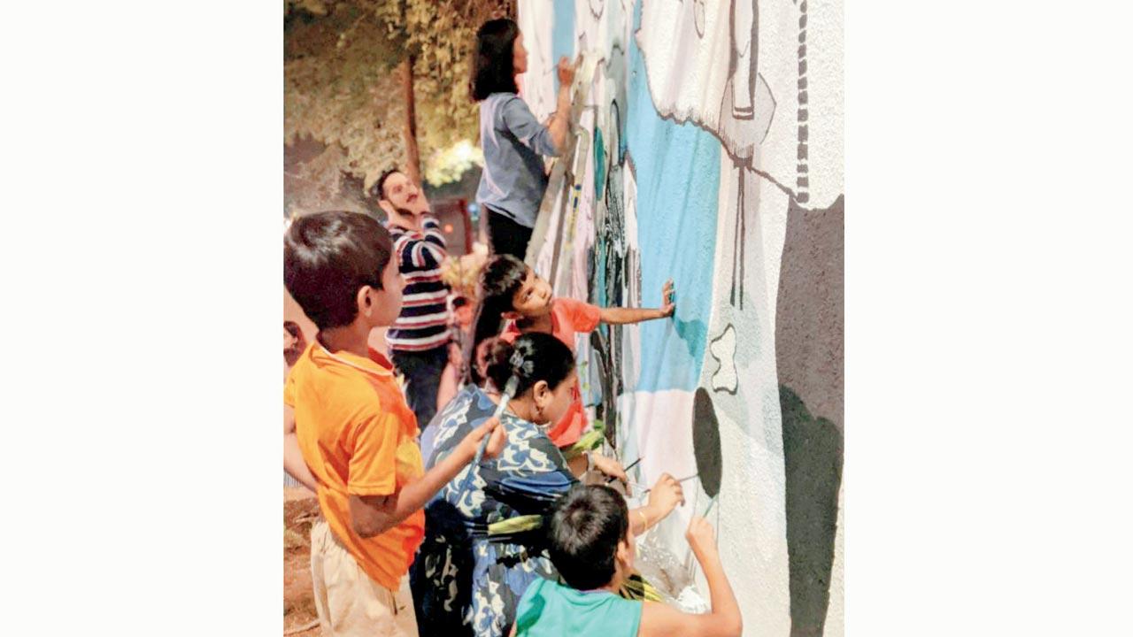 Artists and children paint a previous mural. Pics Courtesy/thestepsbandra