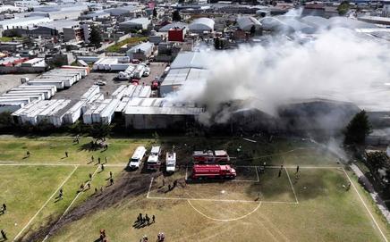 Emergency teams tackle fire after Cessna Citation crashes into warehouse near Toluca Airport, Mexico State, on Dec 15. PIC/ AFP