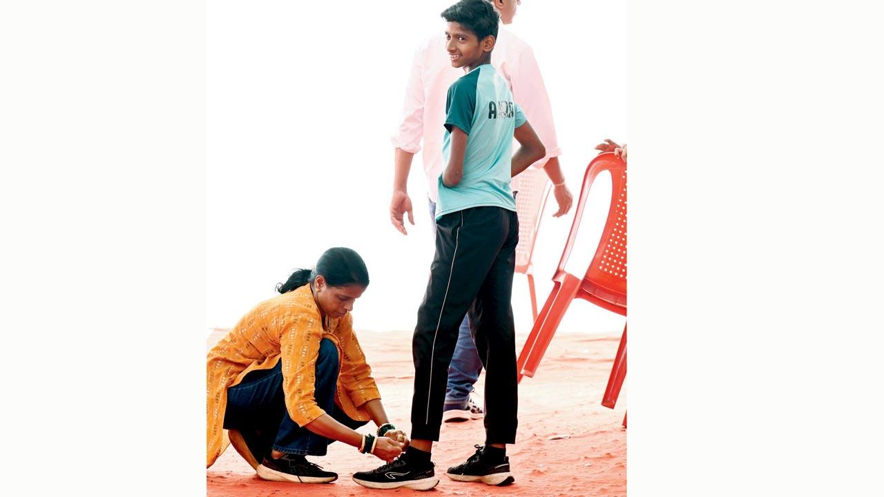 Anuraj Sawant’s mother Sharvari (left) ties his shoelaces at Wings Sports Centre, Bandra, on Tuesday. Pics/Satej Shinde