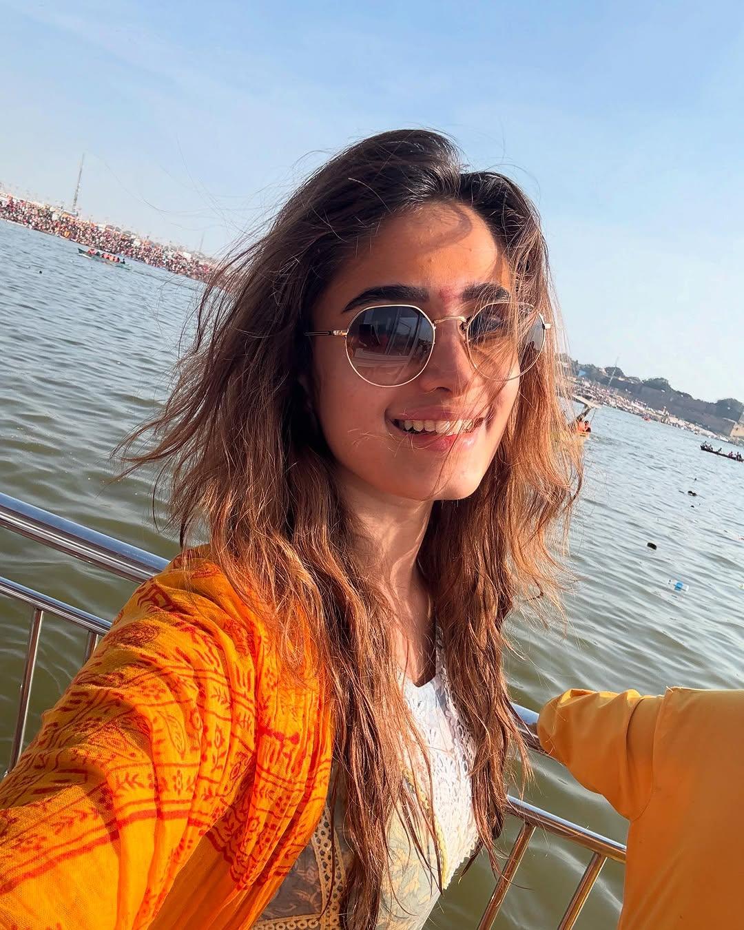This picture shows Rasha smiling ear to ear as she wears stylish sunglasses