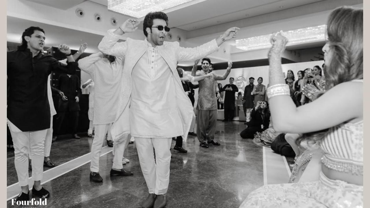 Aadar happily performs as his bride Alekha cheers for him