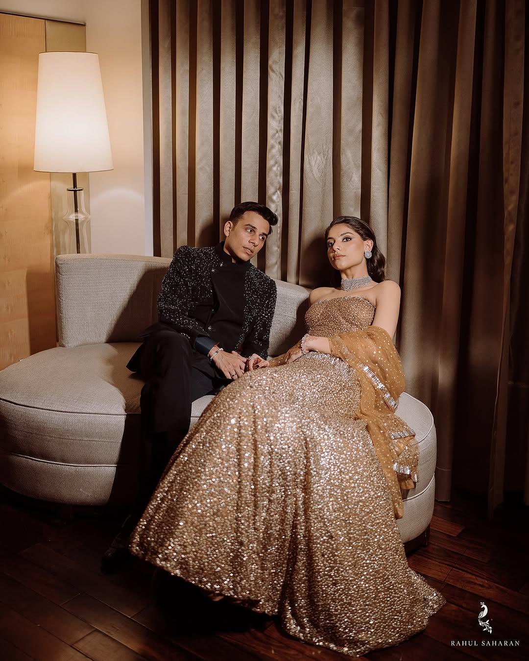 For one of their wedding festivities, Anuv stunned in a black three-piece suit, while his now-wife stole hearts in a golden shimmery skirt paired with a tube top and a dupatta