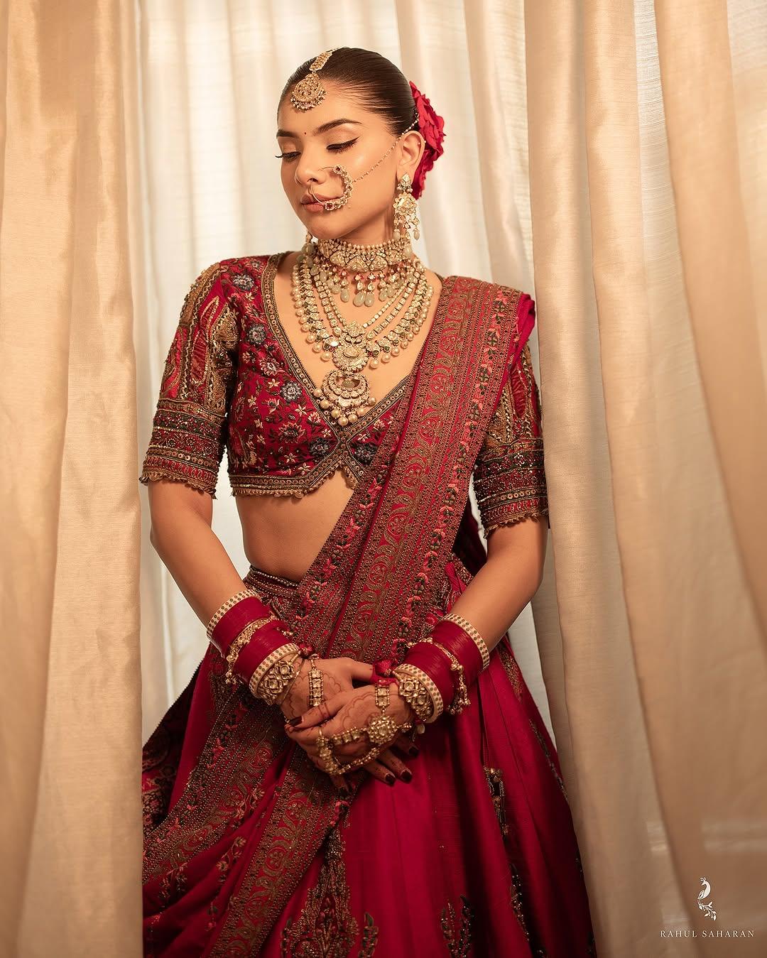 With her stunning red lehenga, the bride tied her hair back in a bun and adorned it with beautiful flowers and stylish, intricate jewellery