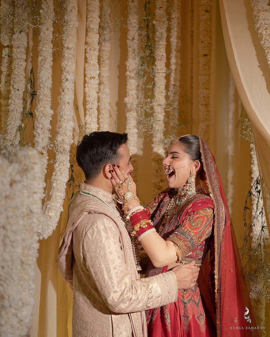 Anuv Jain opted for a beige sherwani, while his now-wife Hridi stunned in a beautiful red embroidered lehenga set