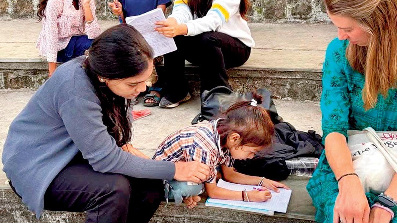 Volunteers guide a child at Carter Road promenade