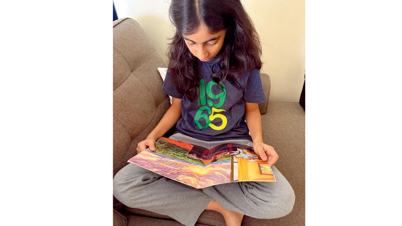 Faria Siddiqi pores over a panel from the illustrated book