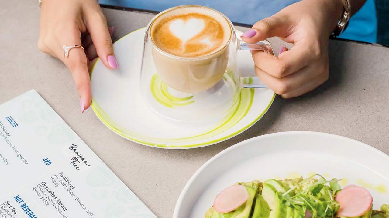 A latte served with a pairing of avocado toast