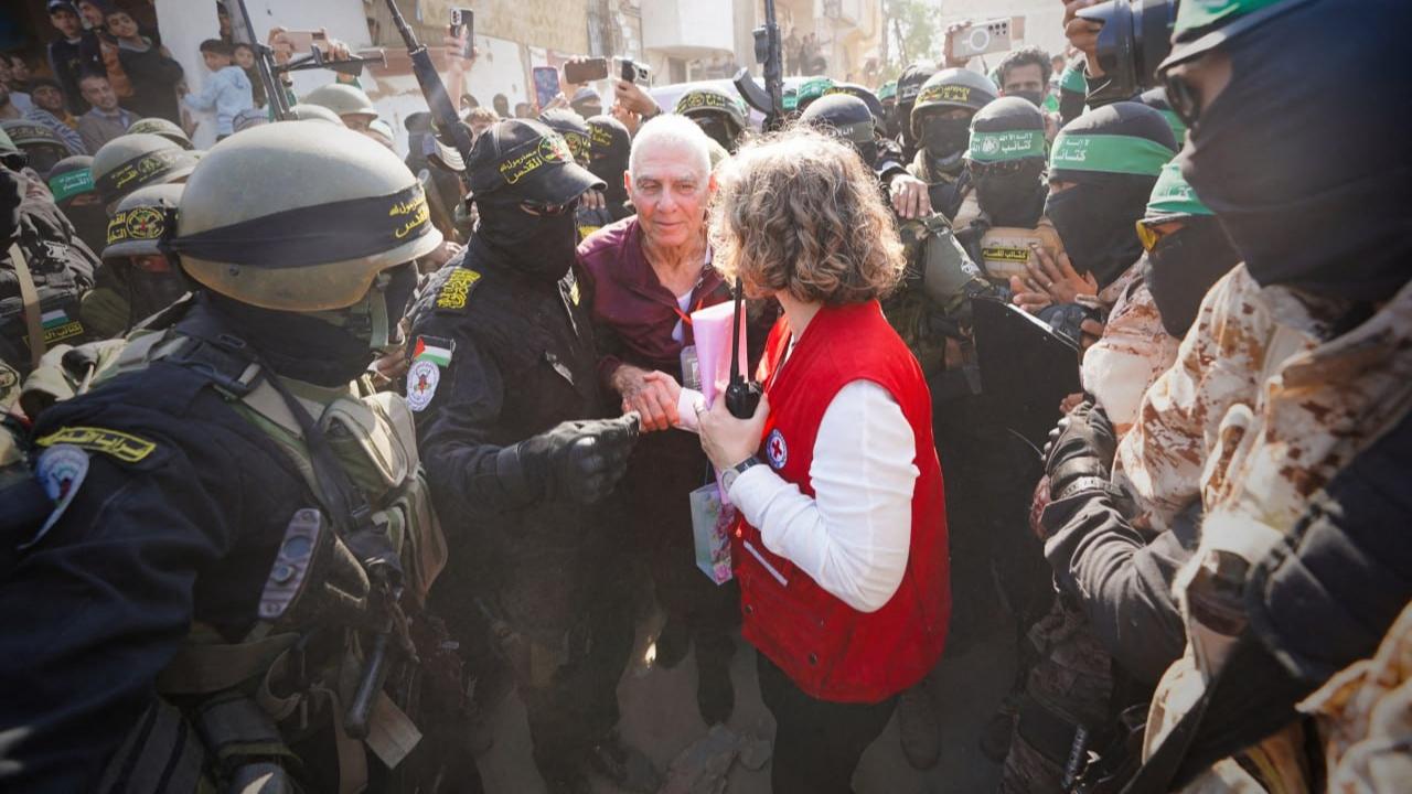 The militants released Yarden Bibas, 35, and French-Israeli Ofer Kalderon, 54, to the Red Cross after each climbed on a stage and waved to onlookers. Both had been abducted during the Hamas-led attack on Israel on Oct. 7, 2023, that sparked the war. Armed Hamas militants formed a line leading to the stage after chaotic crowds surrounded hostages during a handover Thursday, angering Israel