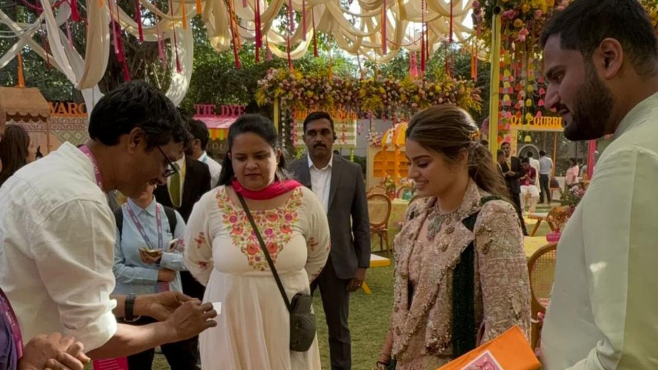 Jeet and Diva in a lively banter with Prakash ji, a nail artist crafting bookmarks using his unique nail art technique with his finger nail to create them.