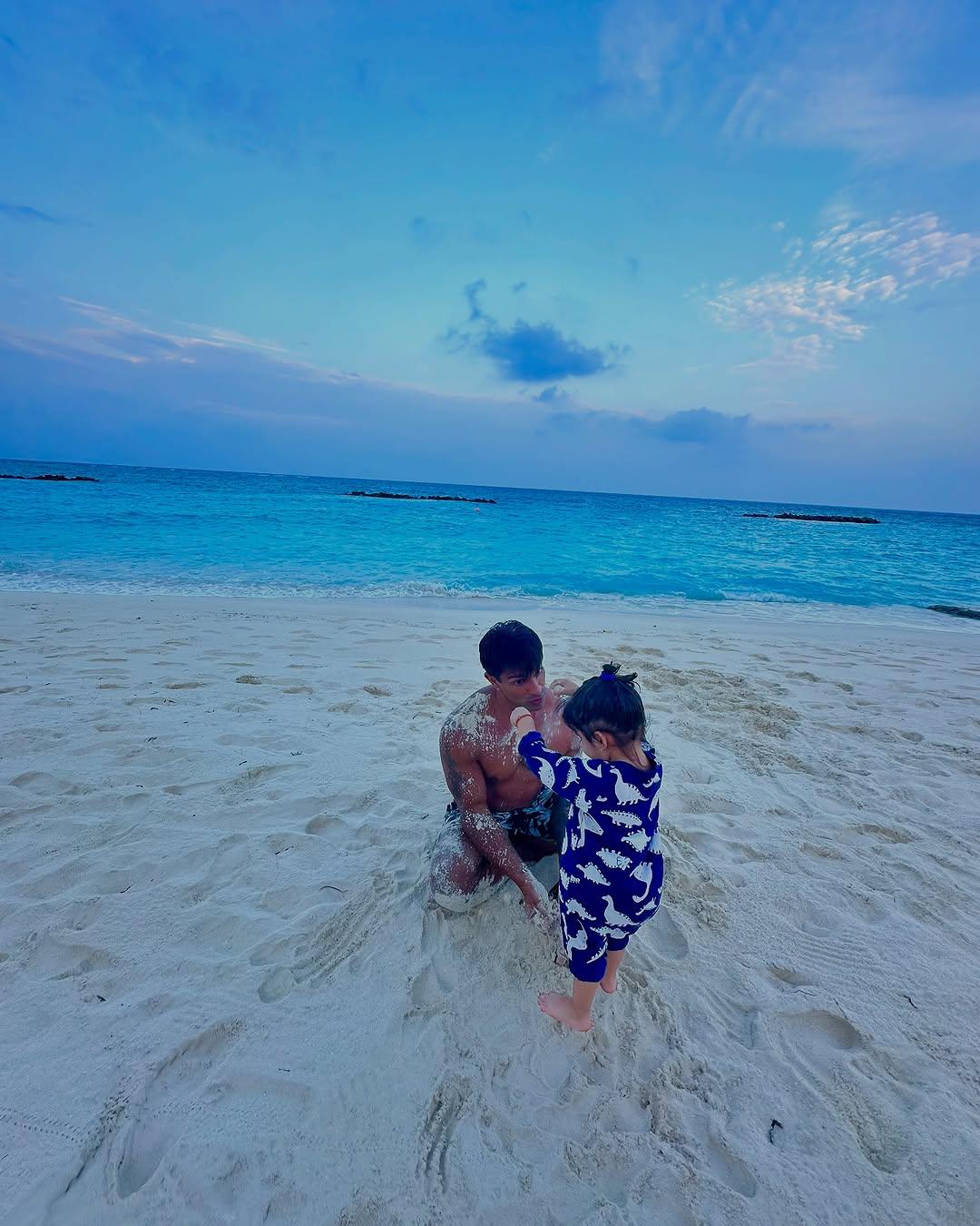 Another picture shows how Devi is surely a daddy's girl. The actor was seen playing with his baby girl in the sand