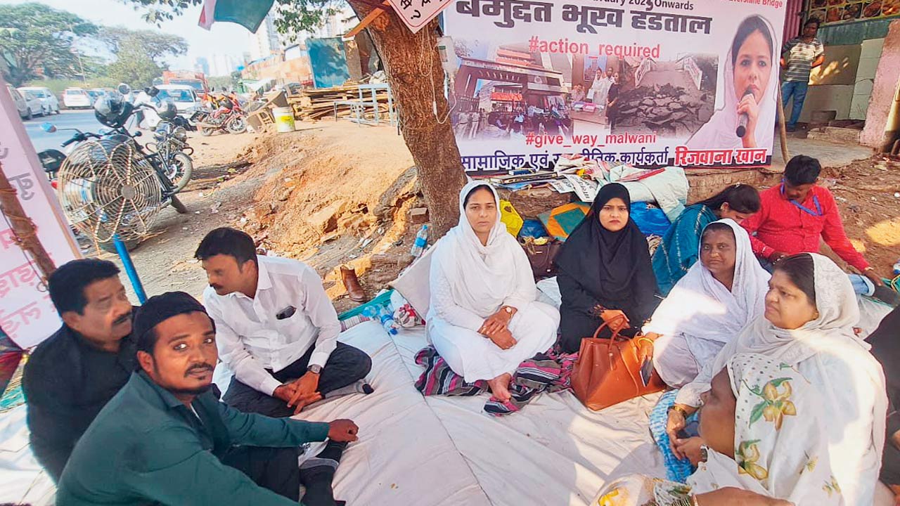 People under the banner of Malwani Vikas Manch stage protest outside the BMC office