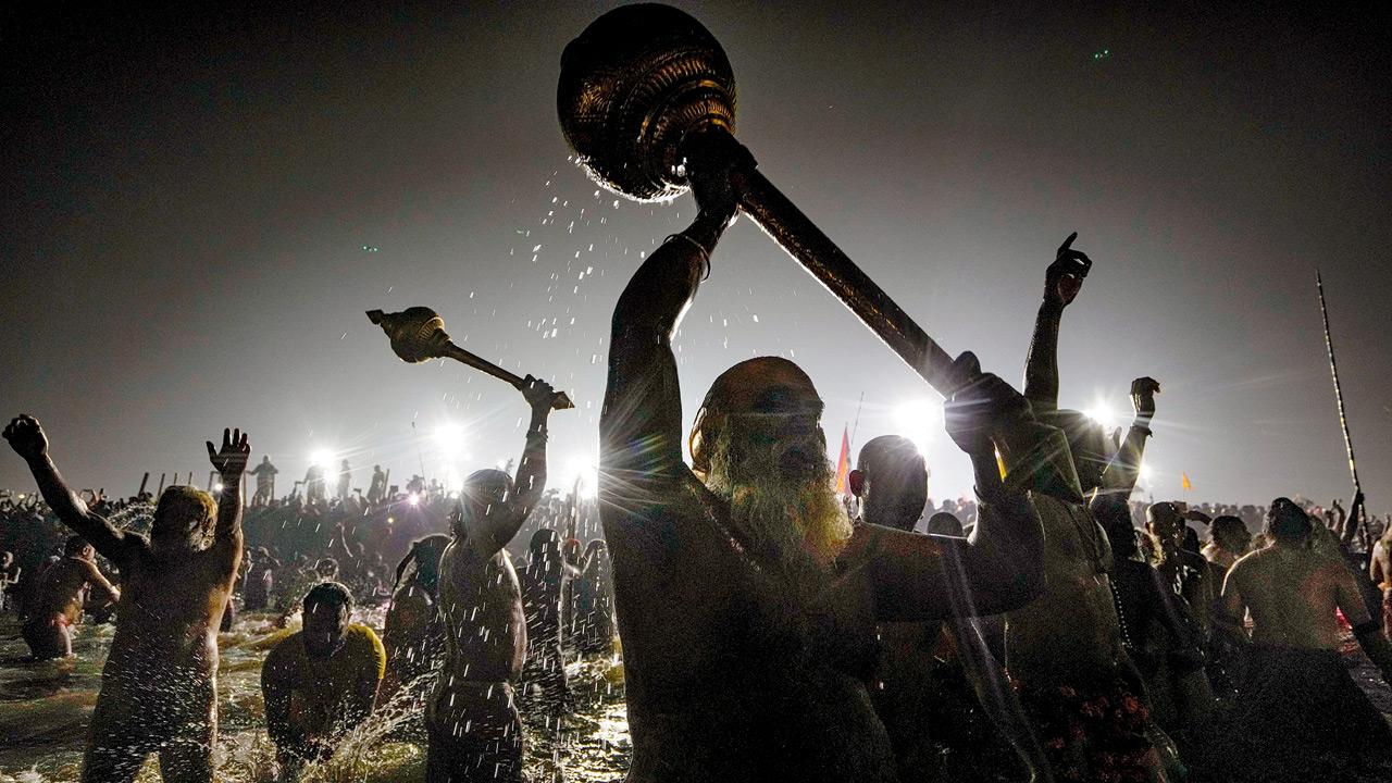 Naga Sadhus while taking a holy dip at the Sangam. Pic/PTI