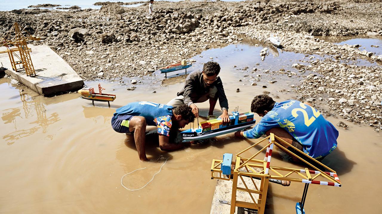 Patil works on fixing a container ship with his team 