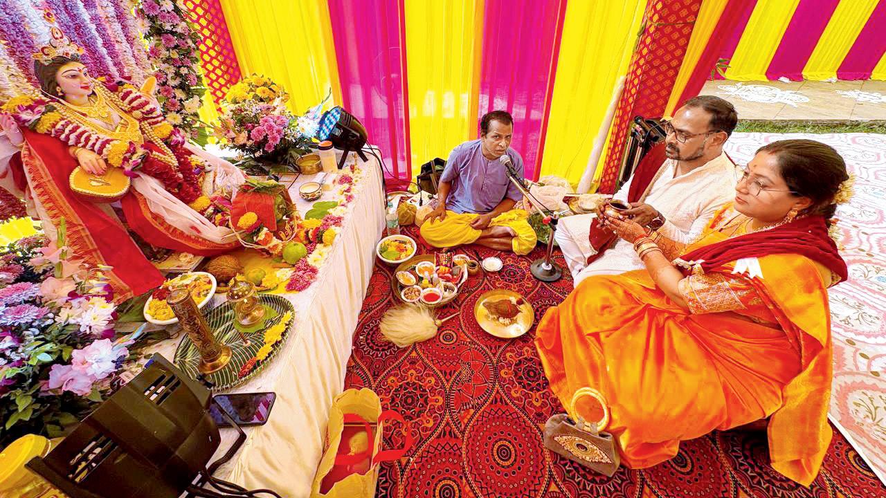 A couple offers prayers during the puja