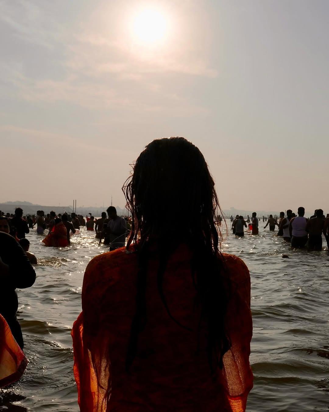 This picture, taken from the background, captures Rasha praying to Surya Dev as she enjoys her spiritual trip