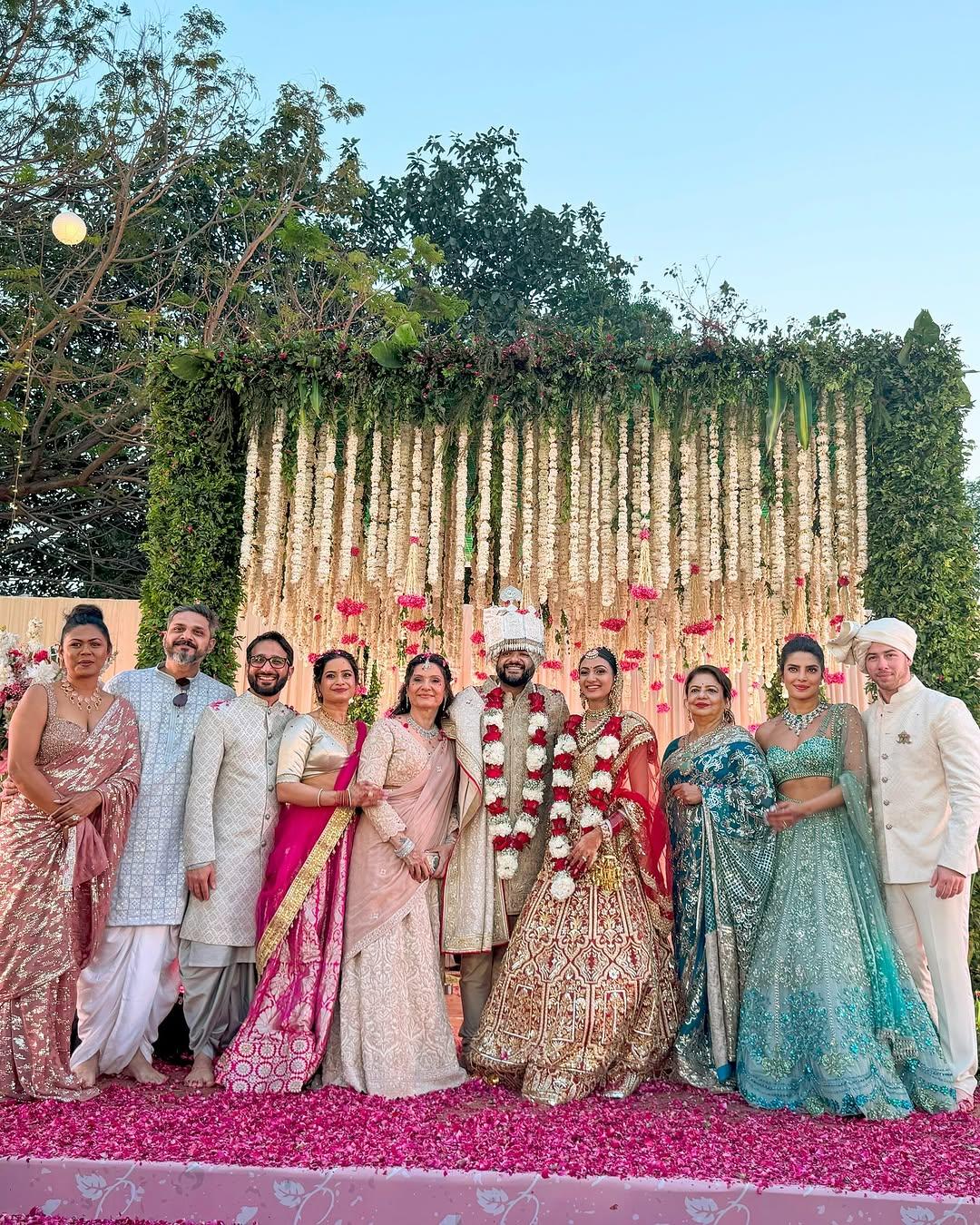 Family photo time! This picture shows the family members posing together as they happily celebrate the newlyweds