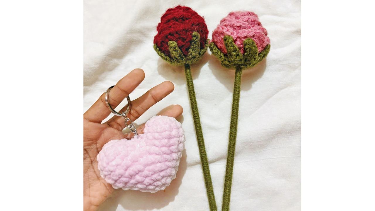 A selection of crochet flowers and a plushie heart keychain