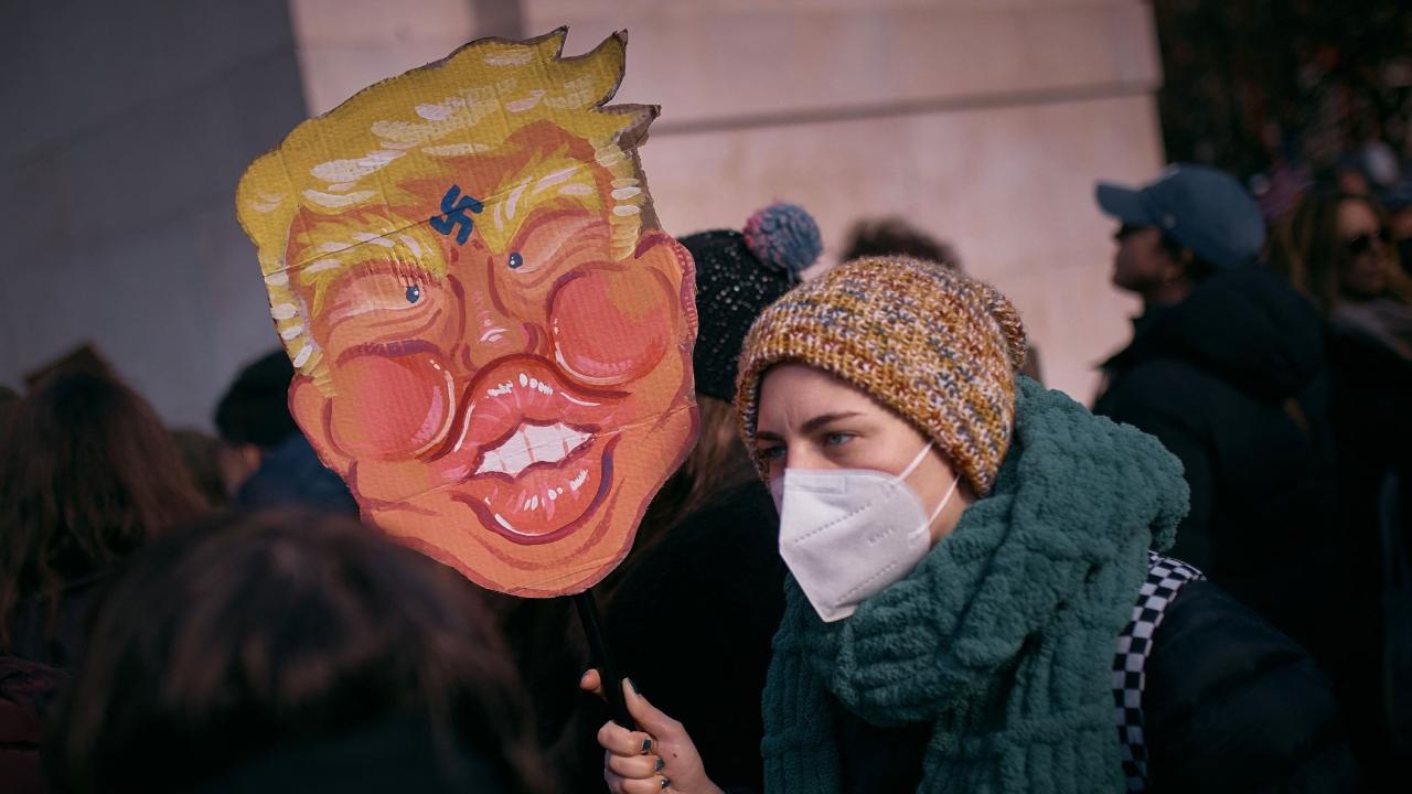 Boston protesters, some dressed in Revolutionary War-style clothing, carried signs saying such things as 