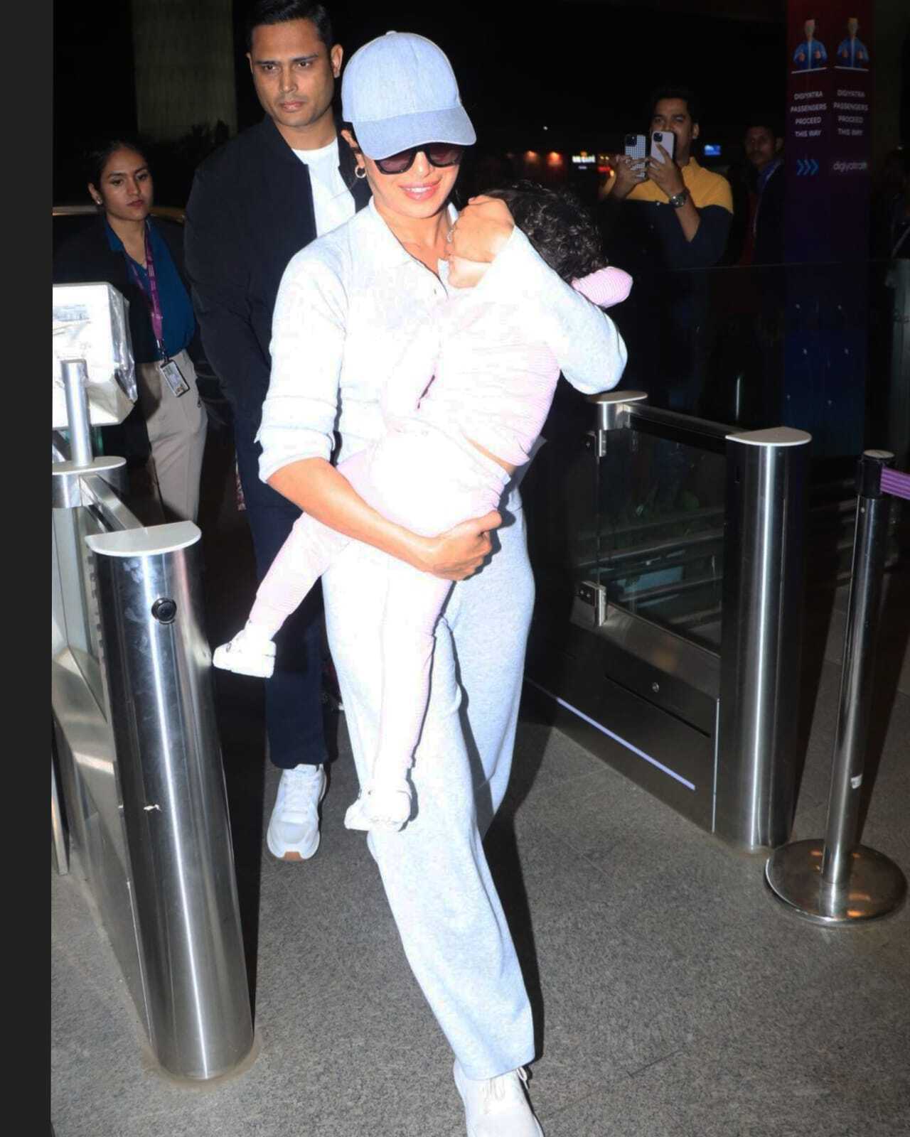 Priyanka Chopra was spotted at the Mumbai airport as she rushed with daughter Malti Marie, whose face was hidden from the paparazzi.