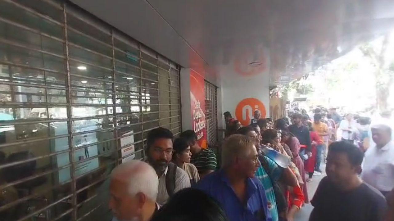 Customers visit New India Co-oprative Bank's Andhri East branch for collecting their things from their locker after RBI notice - Directions under section 35A read with section 56 of the Banking Regulation Act, 1949