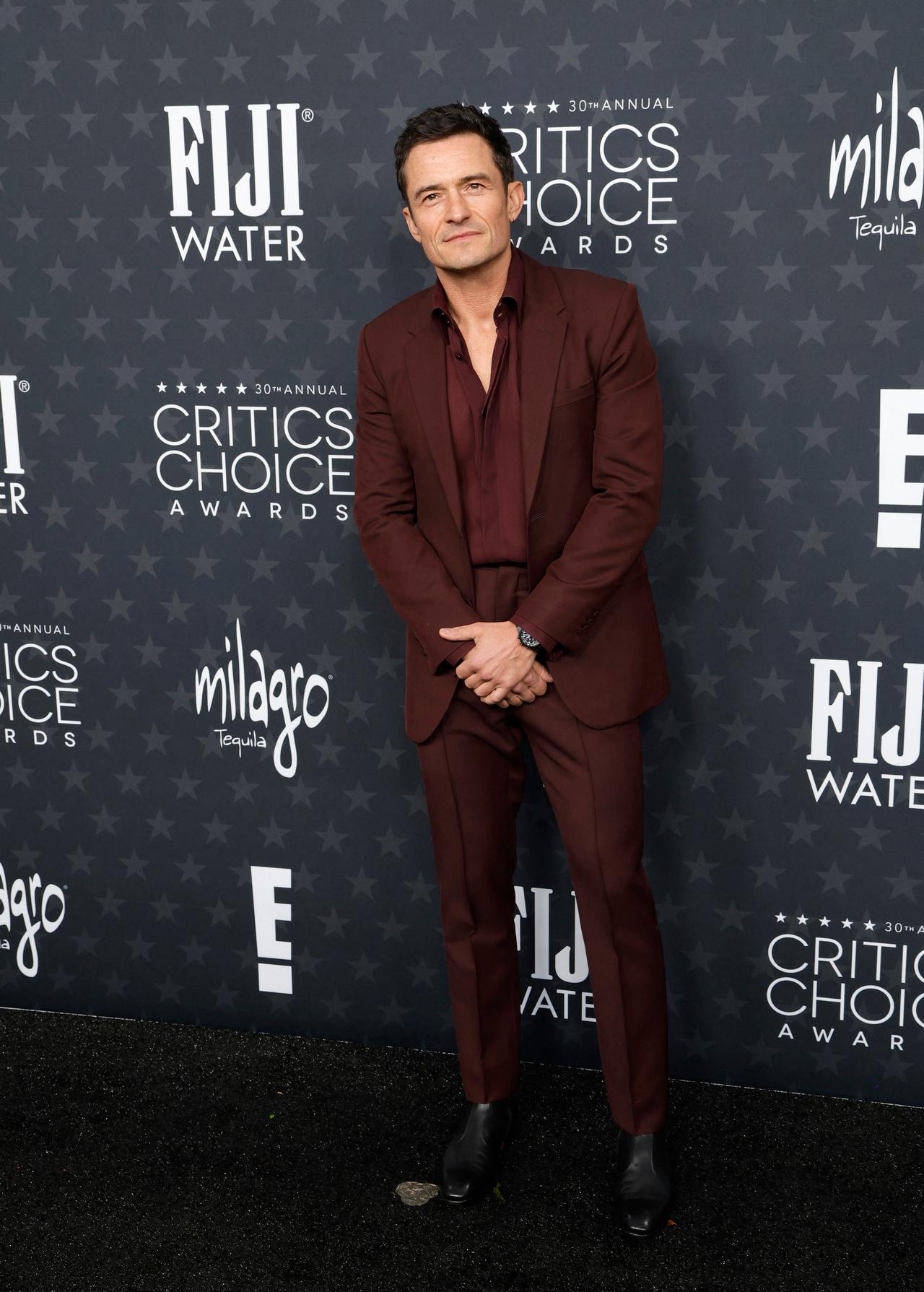 Orlando Bloom looked dapper in a maroon suit