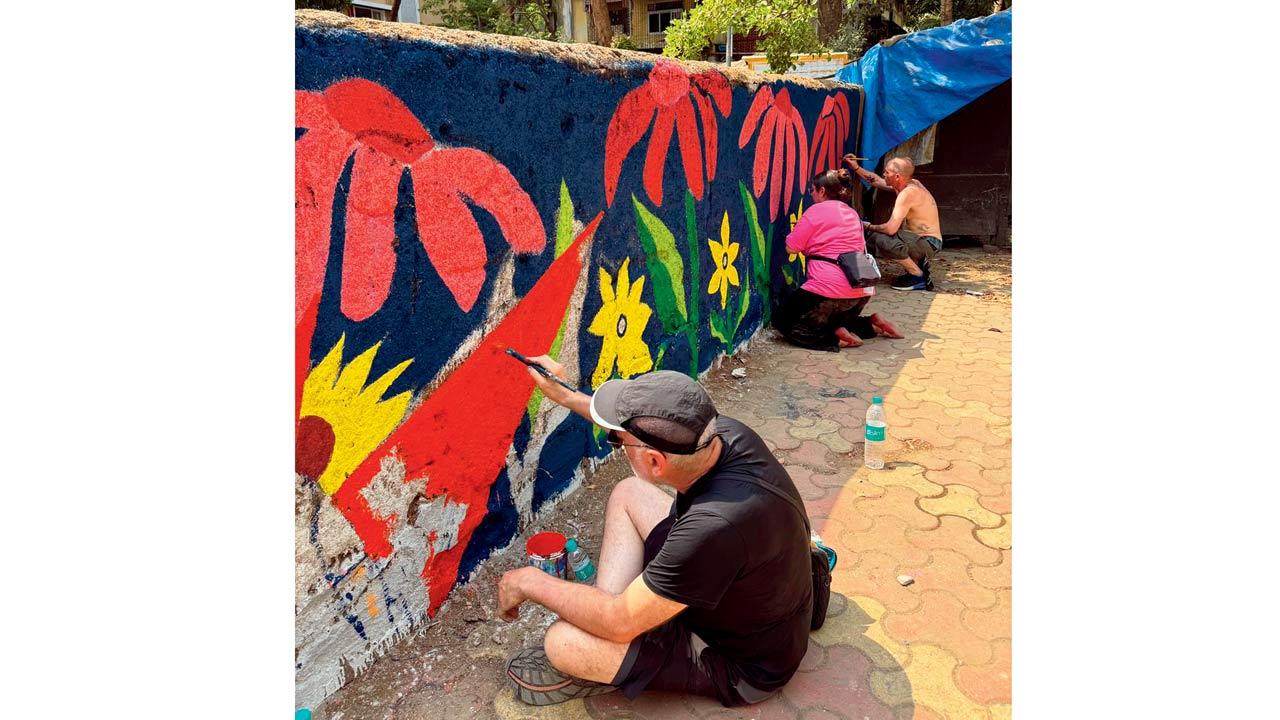 A moment from a community wall painting session in Khar by the art collective 