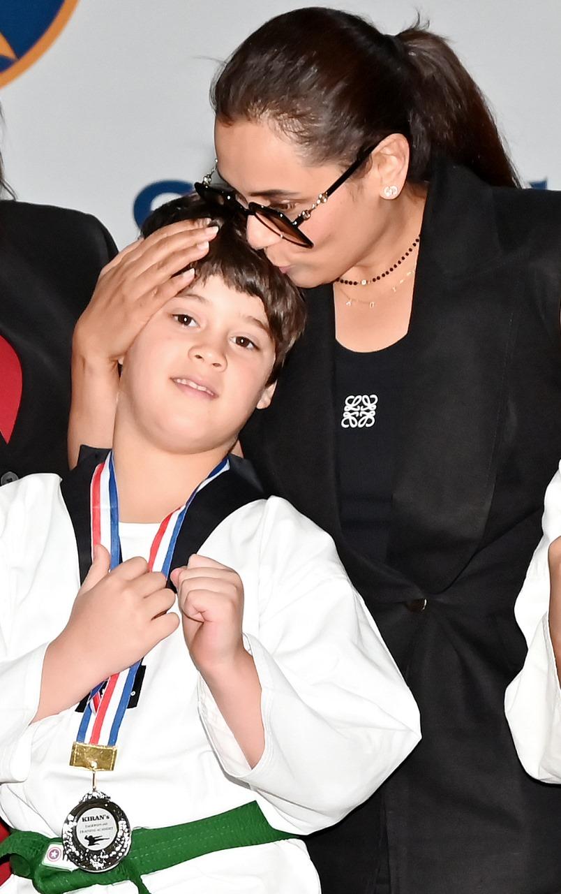 Rani Mukerji can be seen planting a peck on Karan's son Yash's forehead