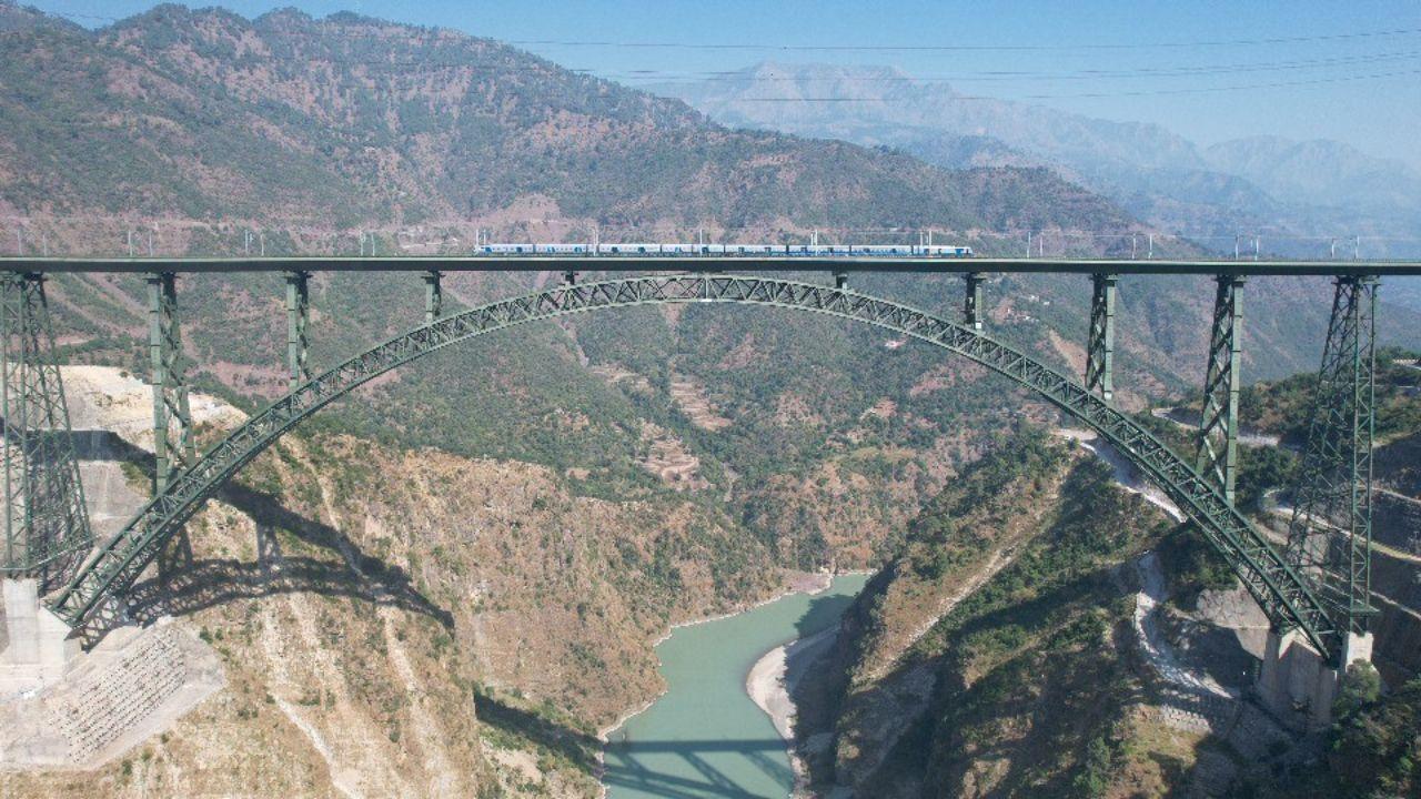 Stretching across a dramatic gorge, the Chenab Bridge offers a breathtaking view of the blue-green waters below, surrounded by towering mountain peaks