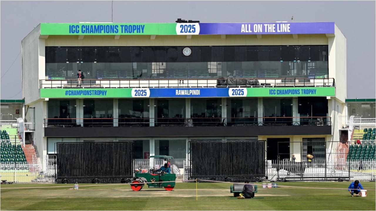 A groundsman uses a roller to prepare the pitch ahead of the ICC Men's Champions Trophy one-day international (ODI) cricket matches at Rawalpindi