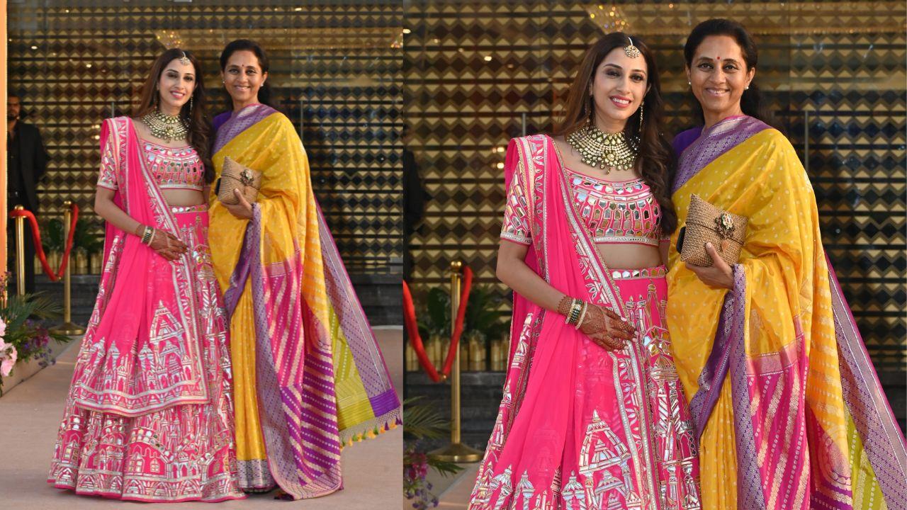 Anissa Malhotra and Supriya Sule shared a beautiful moment at the mehendi ceremony. Anissa stunned in a bright and vibrant pink lehenga, its intricate mirror work featuring stunning motifs of monuments.
Supriya Sule, on the other hand, embraced a classic traditional look, looking regal in a yellow saree. The saree’s vibrant yellow fabric was elegantly framed with pink, purple, and golden borders, adding depth and richness to her ensemble