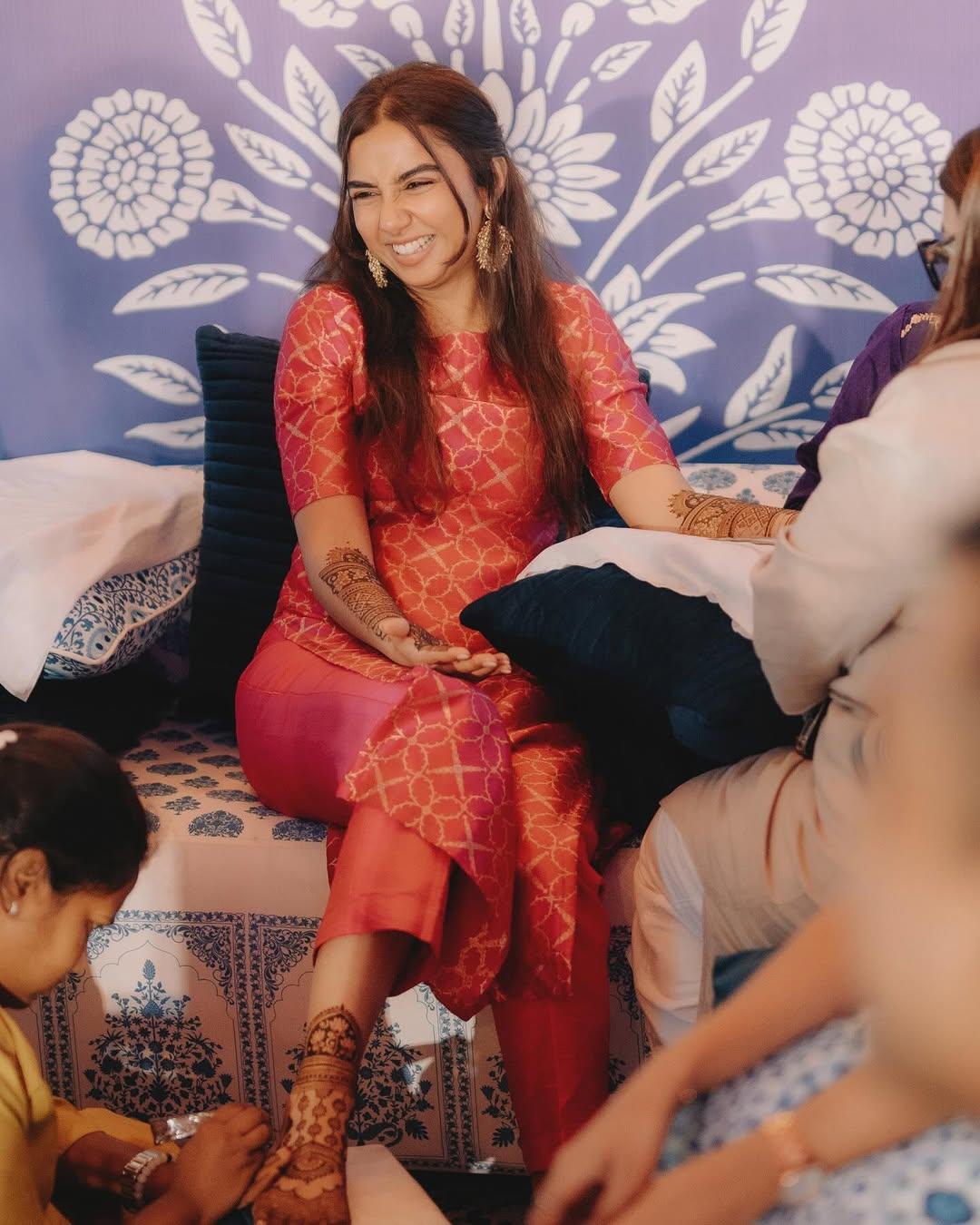 In the snap, Prajakta can be seen smiling bright from ear to ear as the henna artists apply mehendi on the actress' hands