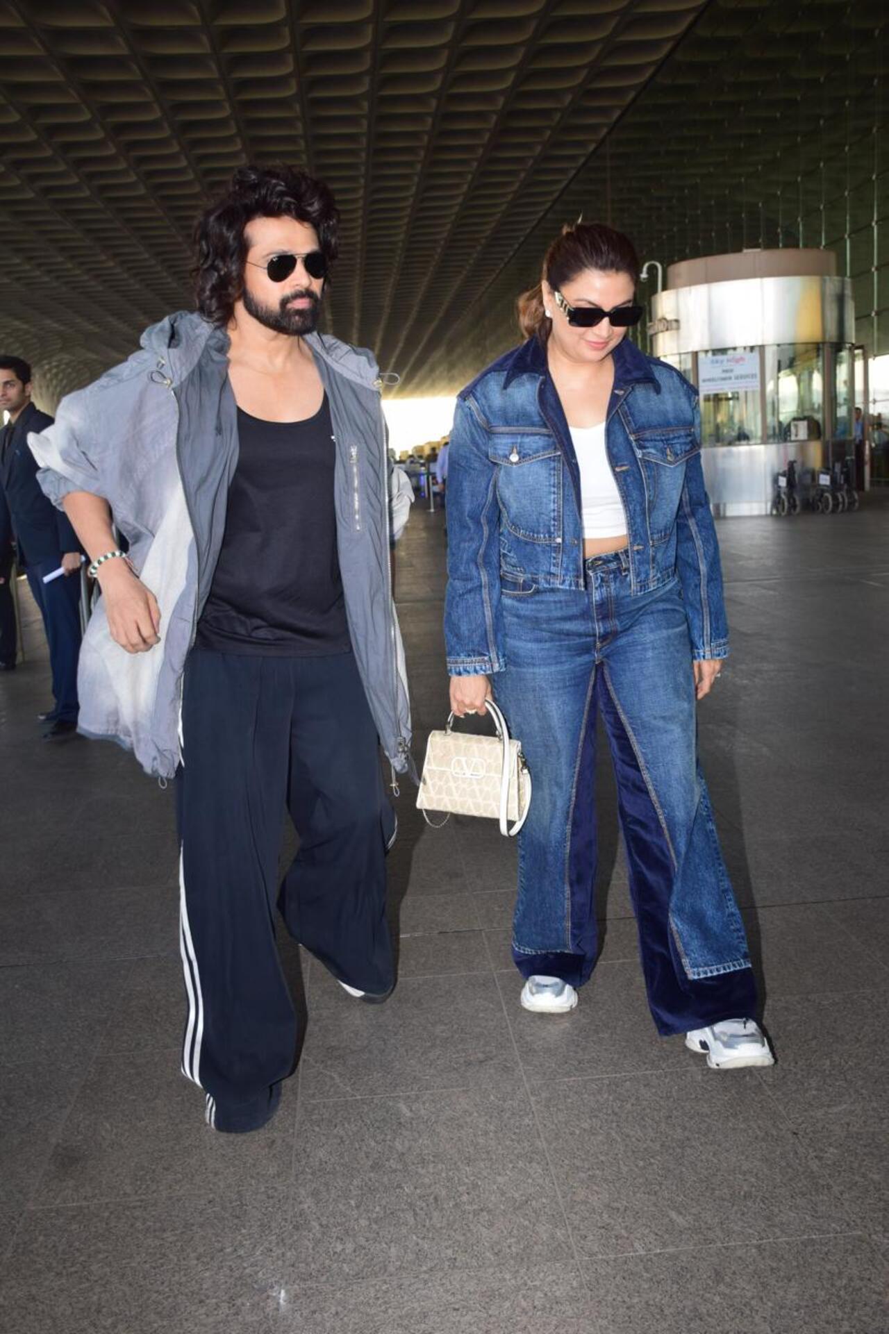 Himesh Reshammiya was spotted with his wife Sonia Kapur at the airport.