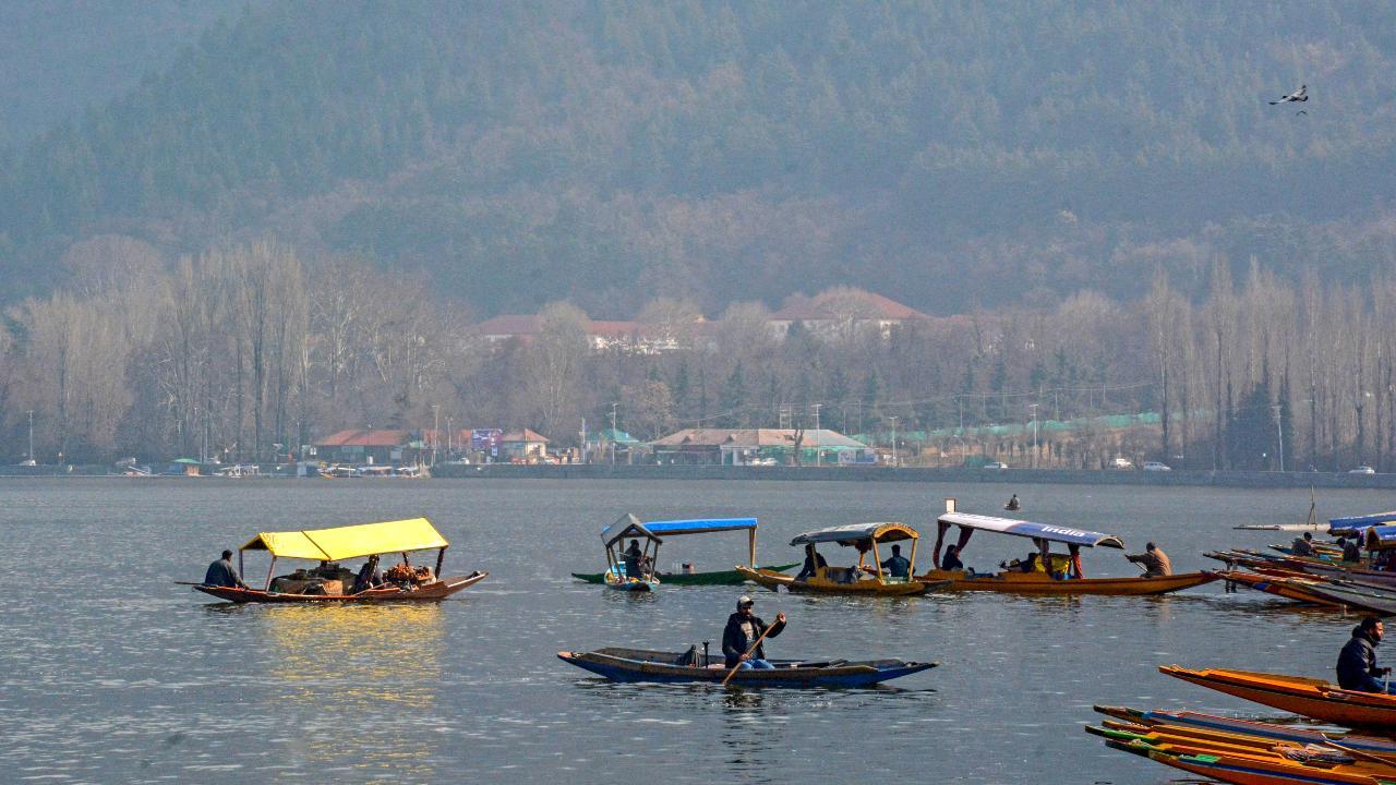 Tourists enjoy shikara ride on Dal Lake in Srinagar amid freezing temperature