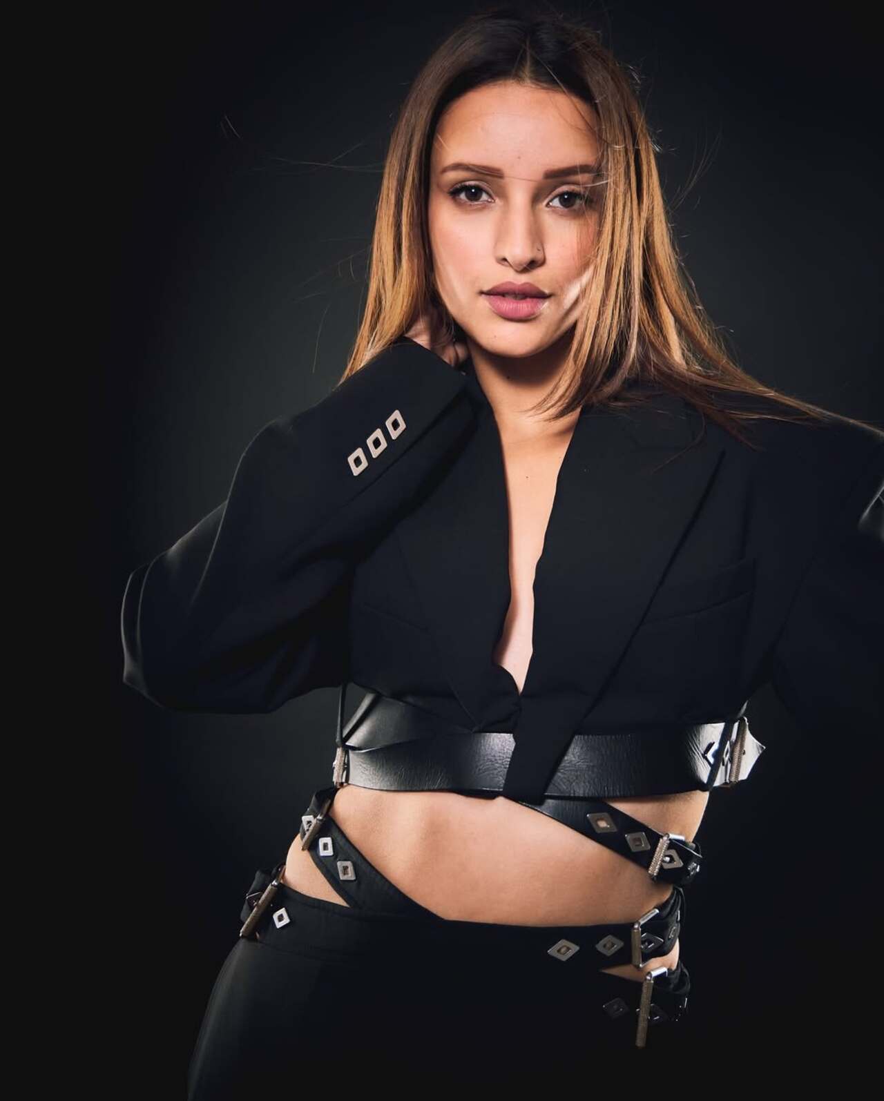 Triptii Dimri stunned in a body-fit black gown featuring elongated sleeves and a collared bust. While she let her outfit do all the talking, she styled her hair in sleek soft waves and opted for dewy makeup.