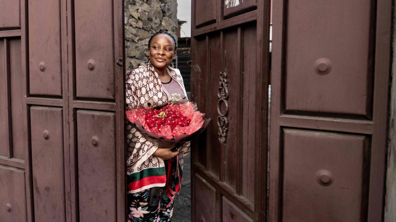 A woman holds a flowers bouquet she received on the occasion of Valentine's Day eve in Congo's Goma. The M23 and Rwandan troops, who have occupied the large city of Goma since the end of January, continue to advance in the east of the Democratic Republic of Congo