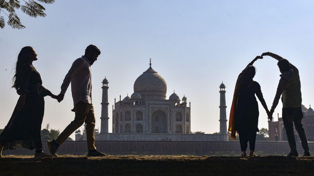 Visitors are seen at Mehtab Bagh in the backdrop of the Taj Mahal on the eve of ‘Valentine’s Day’, in Uttar Pradesh's Agra 