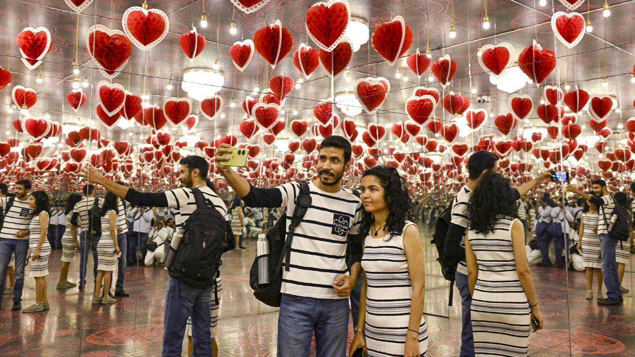 Visitors take pictures inside the ‘Paradox Museum’ amid decorations on the eve of ‘Valentine’s Day’, in Maharashtra's Mumbai