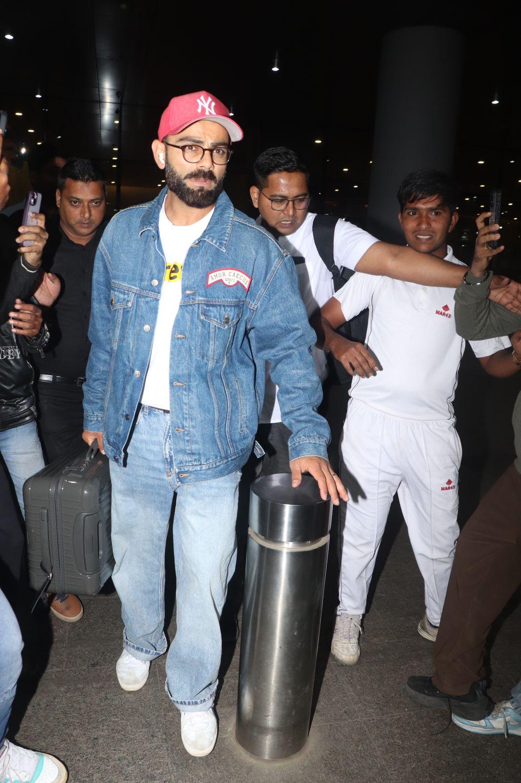 Cricketer Virat Kohli was spotted arriving at the Mumbai airport, dressed casually in a denim jacket and white tee, making his way through selfie-hungry fans and paps