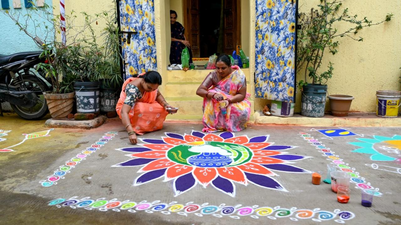 Women decorate the front yard of their house with rangoli designs, on the eve of the harvest festival of Makar Sankranti in Hyderabad (Pic: AFP)