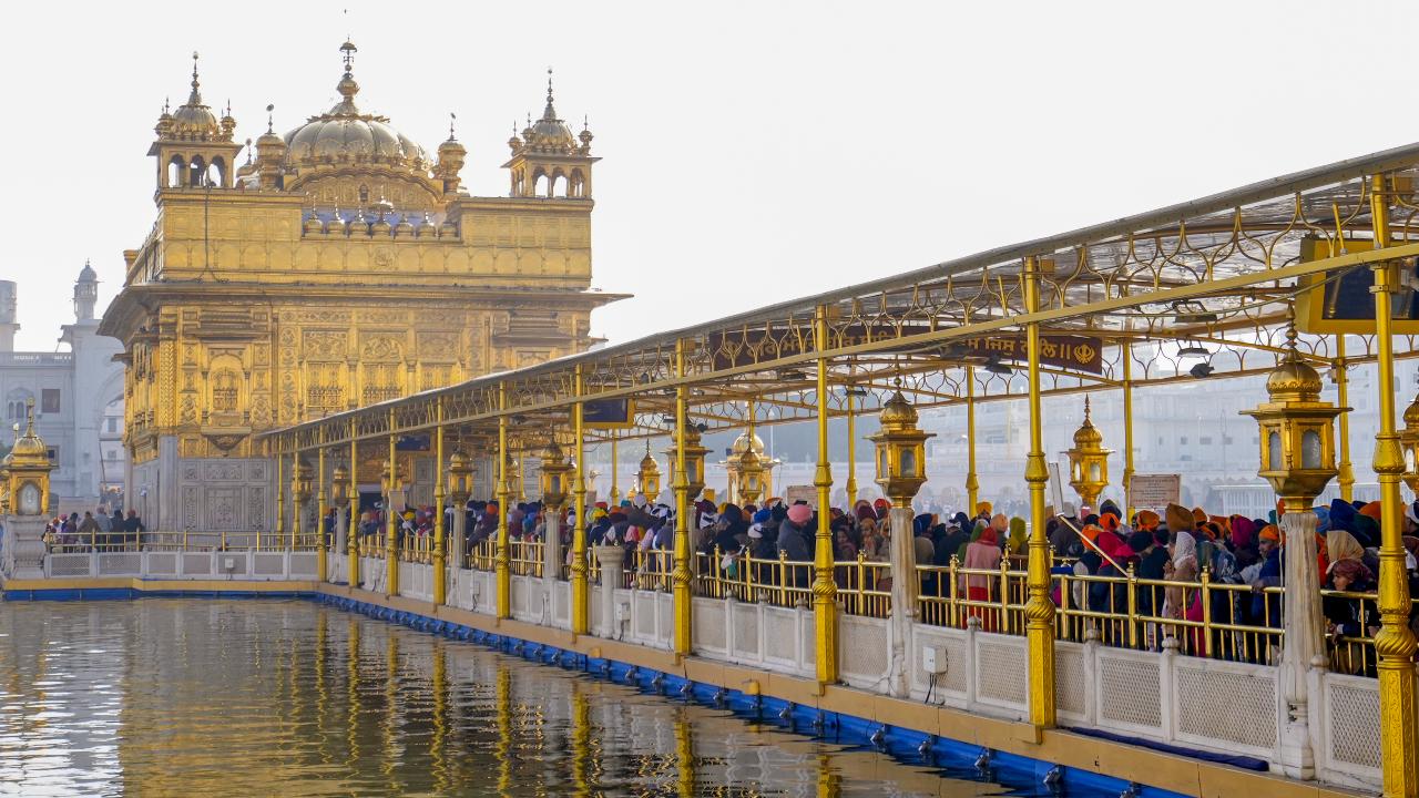 Devotees wait to offer prayers at the Golden Temple on the occasion of Maghi or Makar Sankranti festival in Amritsar (Pic: PTI)