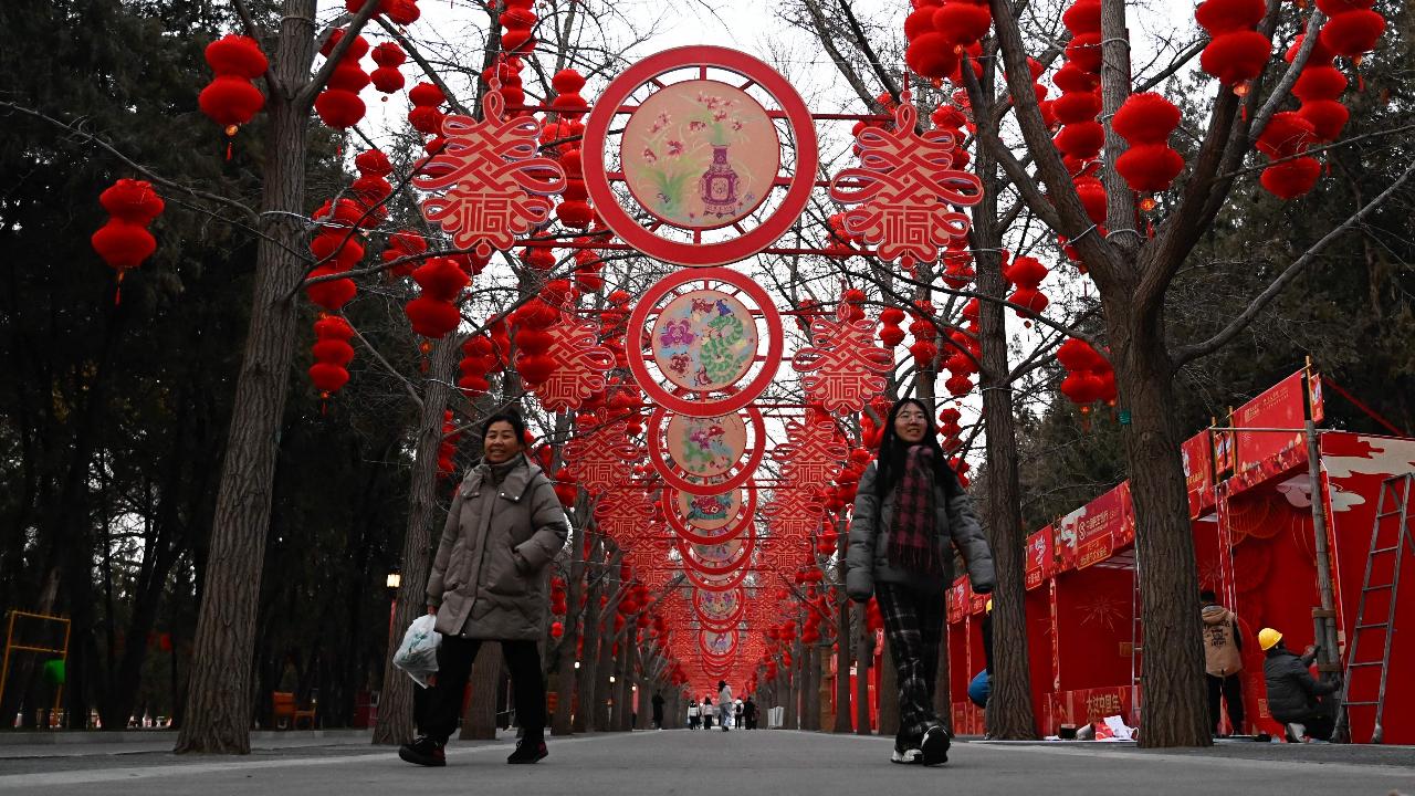 People walk through the decorated Ditan Park in Beijing ahead of the Lunar New Year of the Snake which will fall on January 29