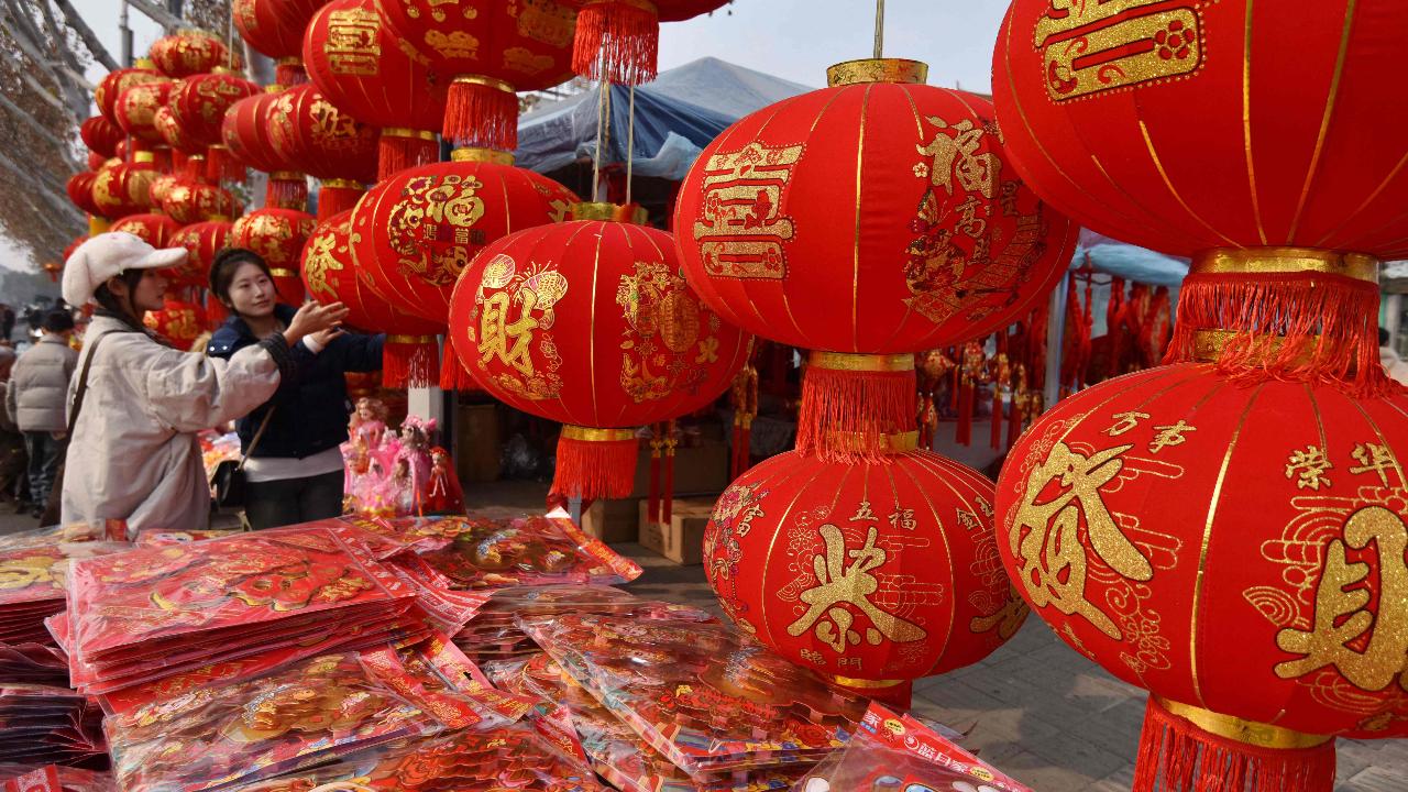 People shop for decorations at a New Year market in Fuyang, in China’s eastern Anhui Province, in the build-up to celebrations of the Lunar New Year
